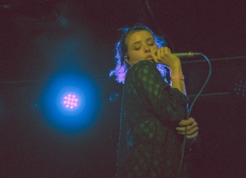 Artist CVMILLE singing on stage. 